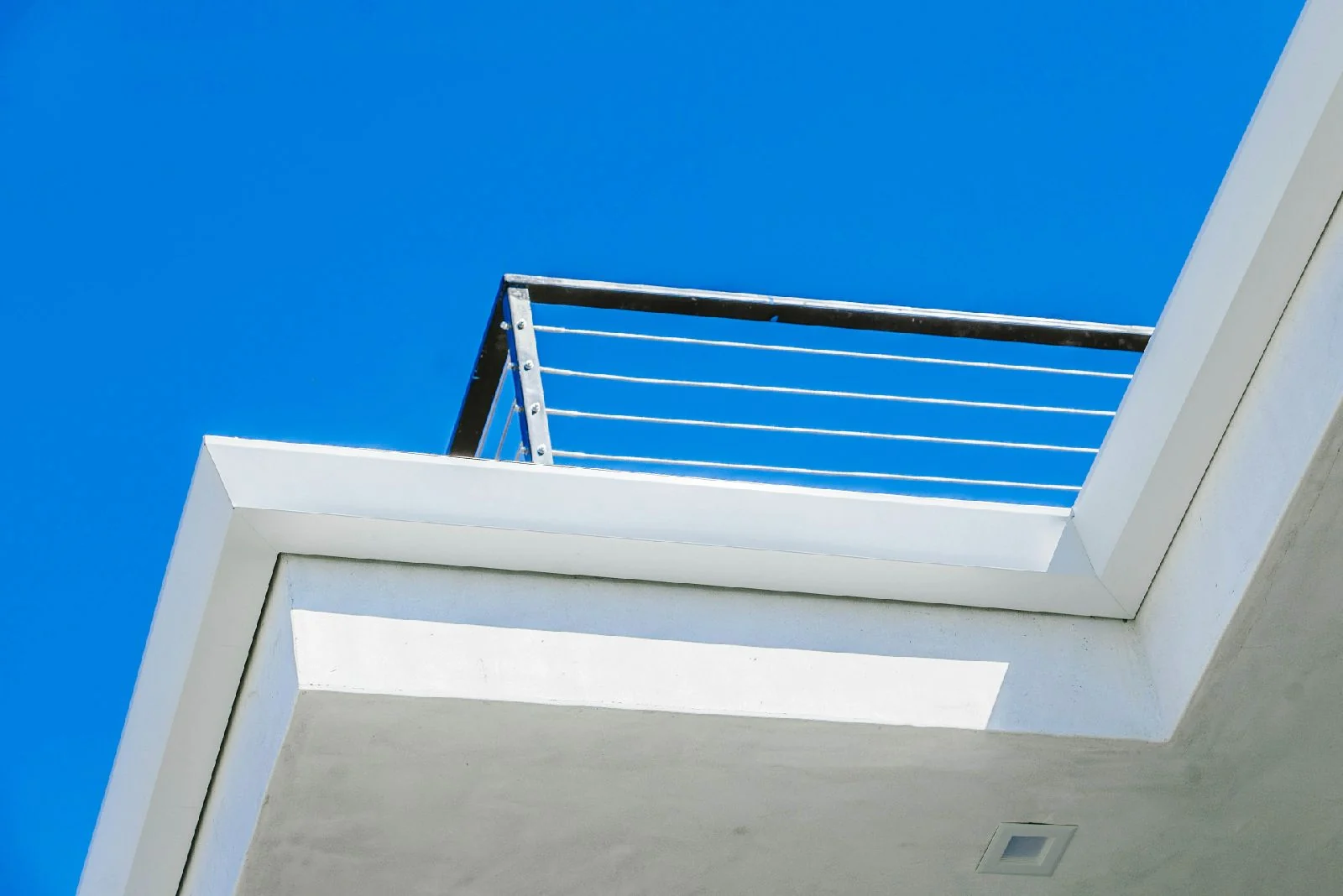 Precisely finished white rain gutters on a modern roofline
