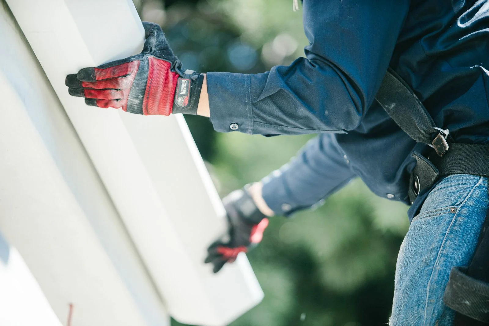 J.R. & Sons team working on a rain gutter installation